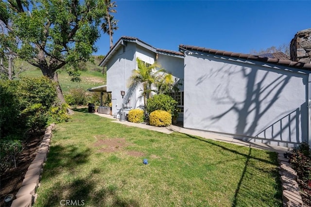 27093 Esward Dr, Calabasas, CA 91301 - view of side of property featuring a lawn, a tiled roof, and stucco siding