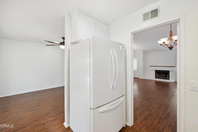 5216 Hillridge Dr, Camarillo, CA 93012 - kitchen with freestanding refrigerator, dark wood finished floors, ceiling fan, a chandelier, and a brick fireplace