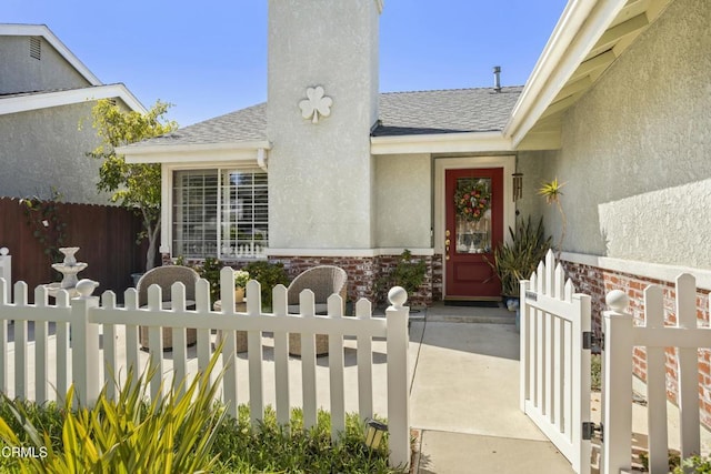5216 Hillridge Dr, Camarillo, CA 93012 - entrance to property featuring a shingled roof, a chimney, stucco siding, a gate, and brick siding