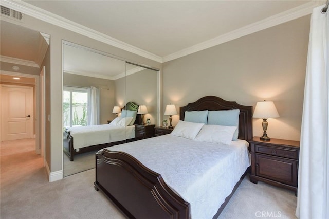 bedroom featuring baseboards, a closet, ornamental molding, light carpet, and visible vents