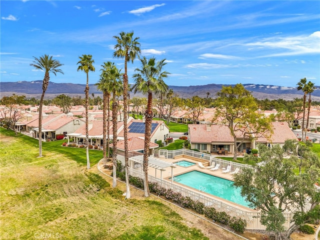 41497 Princeville Ln, Palm Desert, CA 92211 - community pool featuring a residential view, a fenced backyard, a mountain view, and a lawn