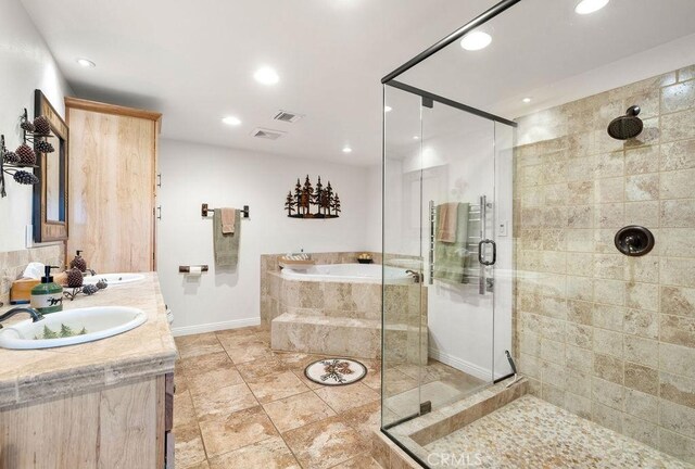 27721 Caribou Dr, Lake Arrowhead, CA 92352 - bathroom featuring a bath, a shower stall, recessed lighting, baseboards, and double vanity