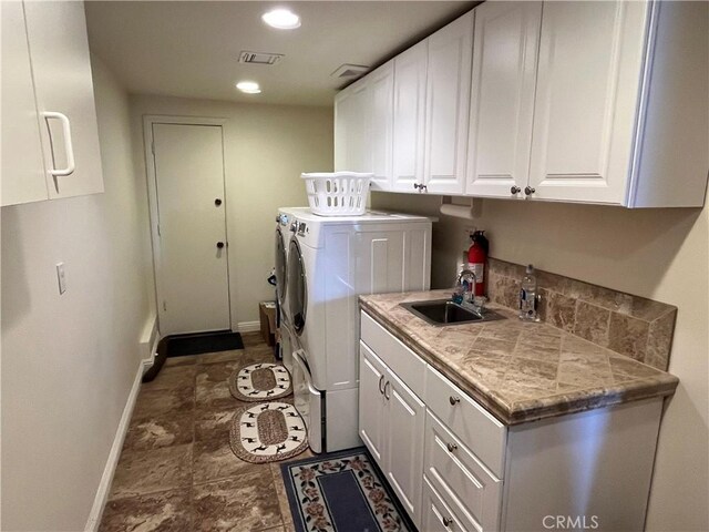 27721 Caribou Dr, Lake Arrowhead, CA 92352 - washroom with baseboards, independent washer and dryer, recessed lighting, and cabinet space