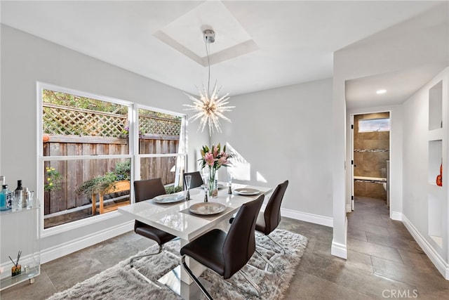 dining space featuring baseboards, a notable chandelier, and recessed lighting