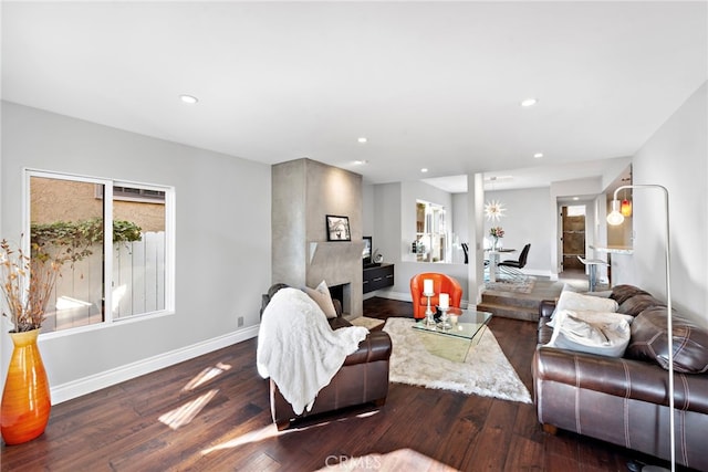 living room with baseboards, wood finished floors, and recessed lighting