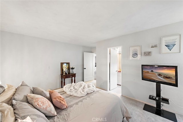 bedroom featuring light carpet and baseboards