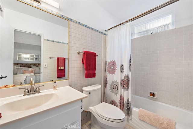 full bathroom with toilet, vanity, shower / tub combo with curtain, and tile walls