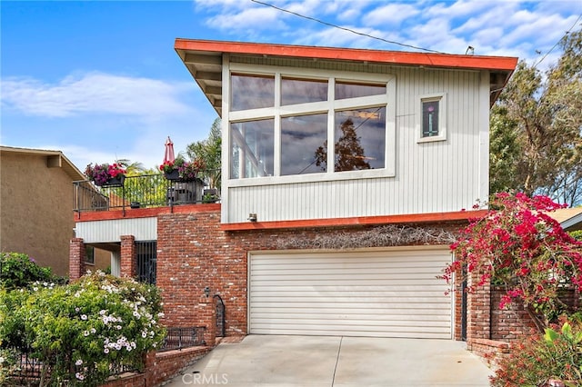 view of side of property featuring a garage and concrete driveway