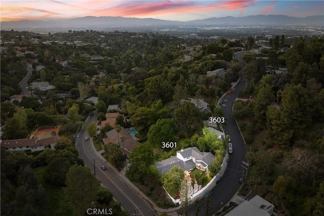 aerial view at dusk featuring a mountain view