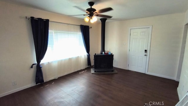 Palmdale, CA 93591 - empty room with a wood stove, ceiling fan, and wood finished floors