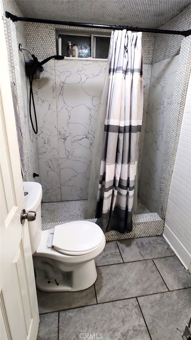 Palmdale, CA 93591 - bathroom featuring a marble finish shower and tile patterned flooring