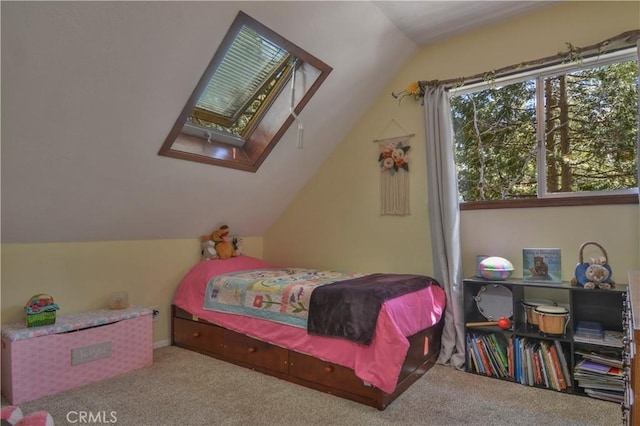 carpeted bedroom with vaulted ceiling with skylight
