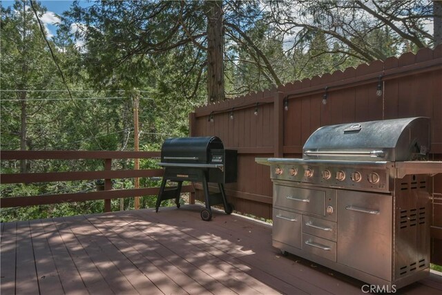 wooden deck with a grill