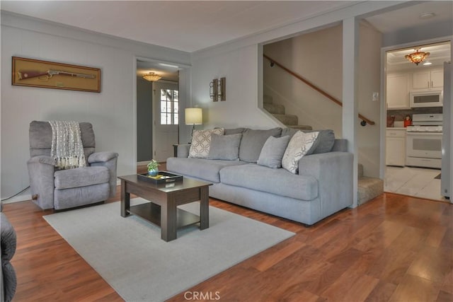 living area featuring wood finished floors and stairway