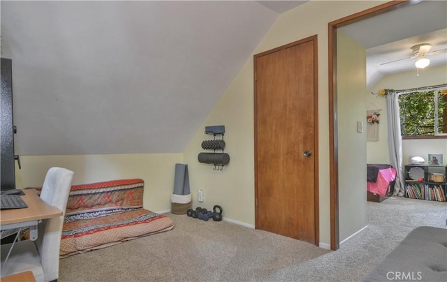 office featuring carpet flooring, a ceiling fan, baseboards, and vaulted ceiling