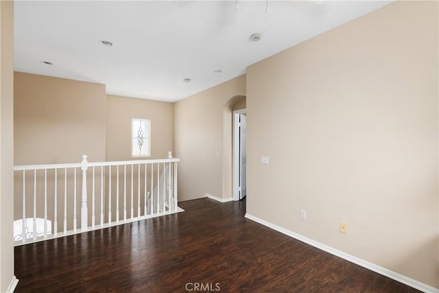 6050 Paseo Carreta, Carlsbad, CA 92009 - spare room with arched walkways, wood finished floors, and baseboards