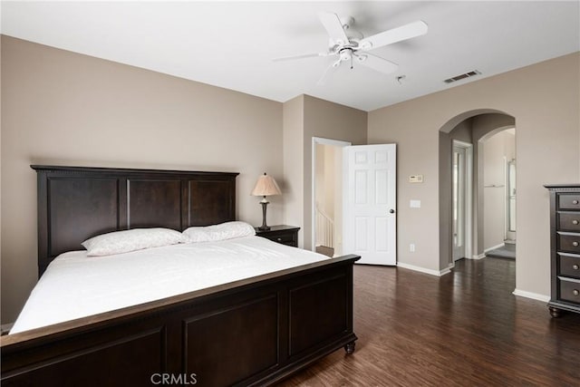 6050 Paseo Carreta, Carlsbad, CA 92009 - bedroom with baseboards, arched walkways, dark wood-style floors, visible vents, and a ceiling fan