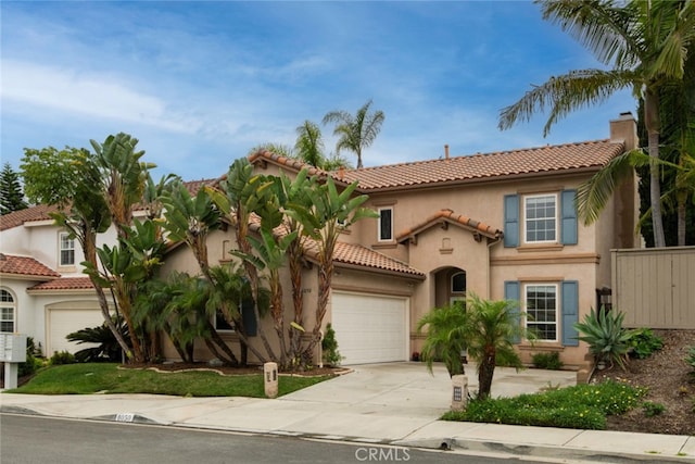 6050 Paseo Carreta, Carlsbad, CA 92009 - mediterranean / spanish-style house with concrete driveway, an attached garage, a tiled roof, and stucco siding