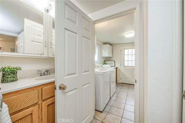 8029 Fruitland Ave, Winton, CA 95388 - washroom with light tile patterned flooring, independent washer and dryer, a sink, and cabinet space