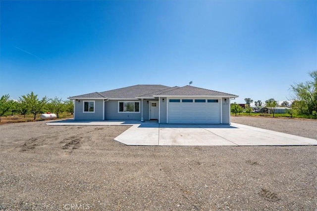 single story home featuring driveway and a garage