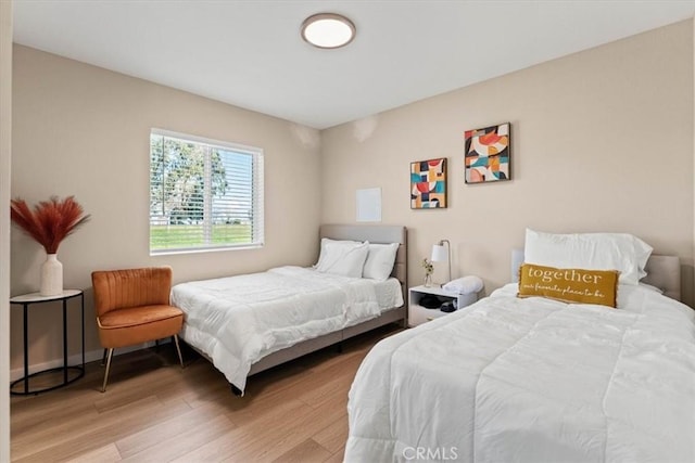 bedroom featuring baseboards and light wood-style floors