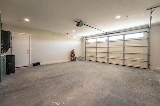 garage with baseboards, recessed lighting, and a garage door opener