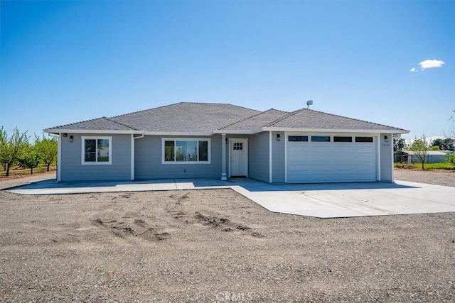 single story home featuring driveway and an attached garage