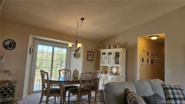 dining area with an inviting chandelier, a textured ceiling, light colored carpet, lofted ceiling, and baseboards