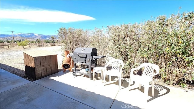 view of patio with a grill and a mountain view
