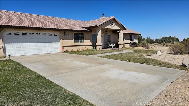 single story home with an attached garage, a tiled roof, concrete driveway, and stucco siding