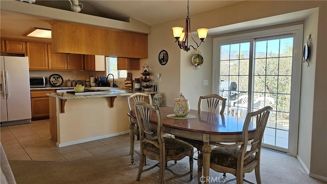 dining space featuring baseboards, light tile patterned flooring, a notable chandelier, and lofted ceiling