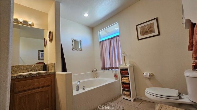 bathroom with vanity, vaulted ceiling, tile patterned floors, toilet, and a garden tub