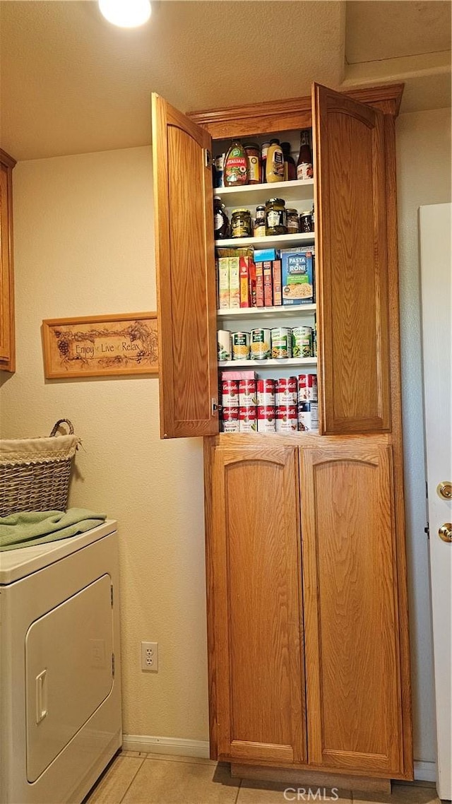 washroom featuring washer / clothes dryer and cabinet space