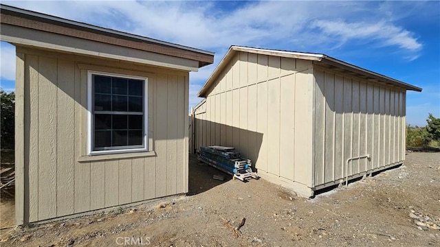 view of home's exterior with an outbuilding and a shed
