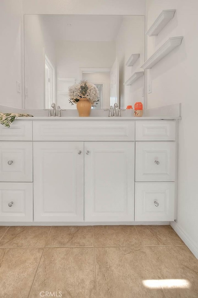 2925 E Via Terrano, Ontario, CA 91764 - bathroom featuring double vanity, tile patterned flooring, and baseboards