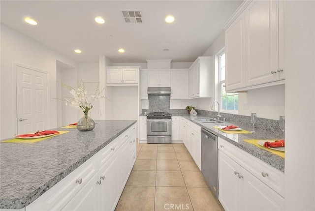 2925 E Via Terrano, Ontario, CA 91764 - kitchen featuring stainless steel appliances, a sink, under cabinet range hood, white cabinetry, and recessed lighting