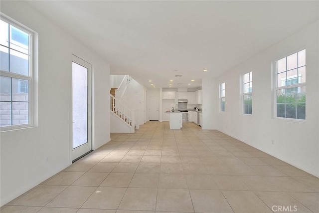 2925 E Via Terrano, Ontario, CA 91764 - unfurnished living room featuring healthy amount of natural light, stairway, light tile patterned floors, and recessed lighting