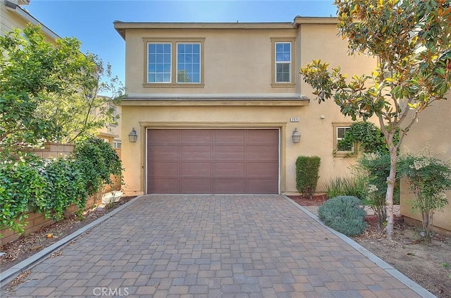 2925 E Via Terrano, Ontario, CA 91764 - view of front of home featuring stucco siding, an attached garage, and decorative driveway