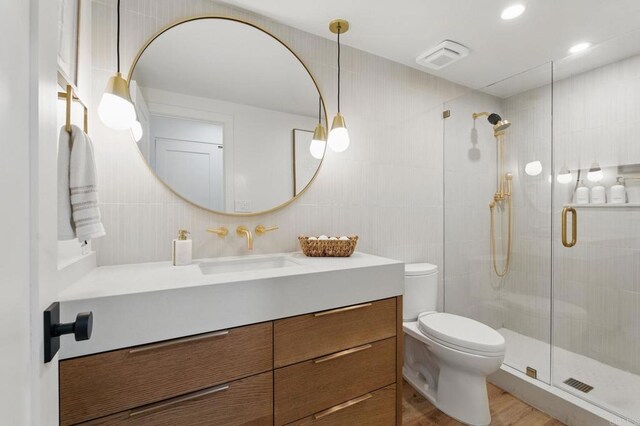 1562 Camino Del Mar Unit 639, Del Mar, CA 92014 - full bath with a shower stall, vanity, tile walls, and wood finished floors
