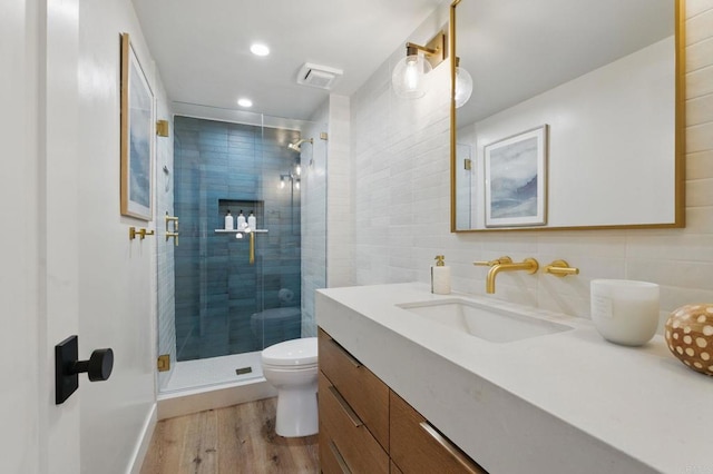 1562 Camino Del Mar Unit 639, Del Mar, CA 92014 - bathroom with vanity, wood finished floors, a shower stall, backsplash, and recessed lighting