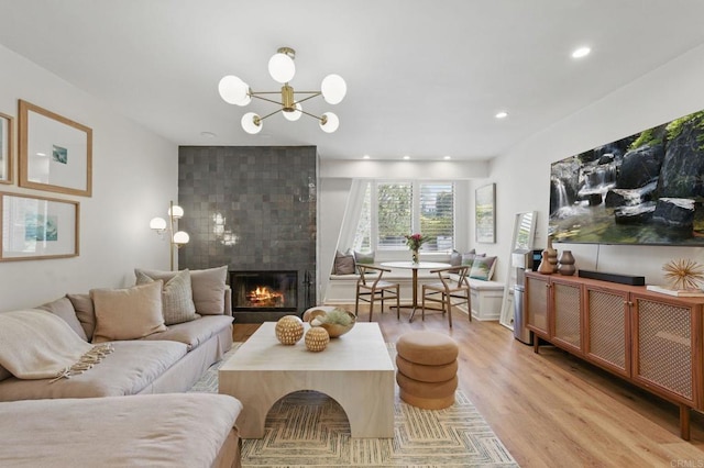 1562 Camino Del Mar Unit 639, Del Mar, CA 92014 - living area featuring light wood-style floors, a large fireplace, a chandelier, and recessed lighting