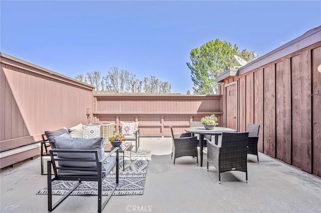 view of patio / terrace featuring fence and outdoor dining space