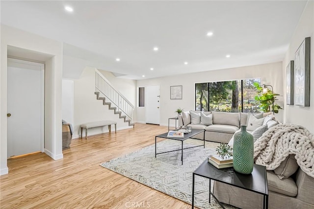living area with baseboards, recessed lighting, stairs, and wood finished floors