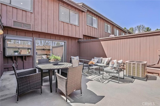 view of patio / terrace featuring cooling unit, an outdoor living space, outdoor dining space, and visible vents