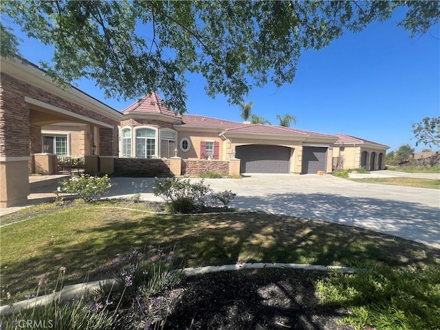 4069 Nancy Cir, Corona, CA 92881 - view of front of home featuring stone siding, an attached garage, concrete driveway, a front lawn, and stucco siding