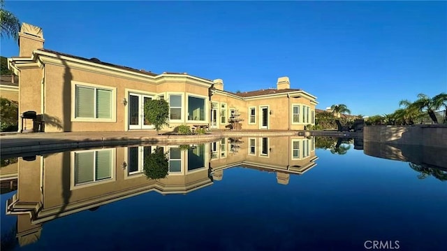 4069 Nancy Cir, Corona, CA 92881 - back of house featuring a chimney, a water view, and stucco siding