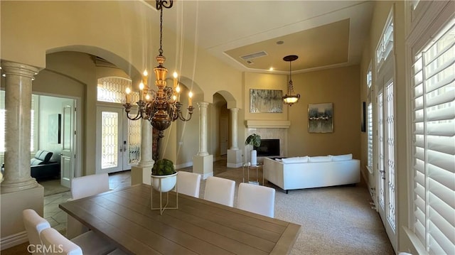 4069 Nancy Cir, Corona, CA 92881 - dining area featuring arched walkways, healthy amount of natural light, carpet floors, and a fireplace