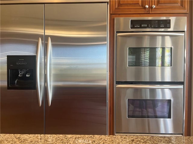 4069 Nancy Cir, Corona, CA 92881 - kitchen featuring stainless steel appliances, light stone counters, and brown cabinets