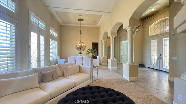 4069 Nancy Cir, Corona, CA 92881 - living room with ornate columns, french doors, arched walkways, a high ceiling, and baseboards