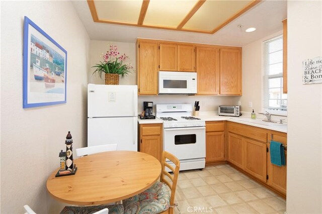 kitchen featuring a sink, light countertops, white appliances, recessed lighting, and a toaster